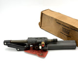 Side profile of the 8M0063382 cylinder assembly showing the brass fittings and red warning tag.