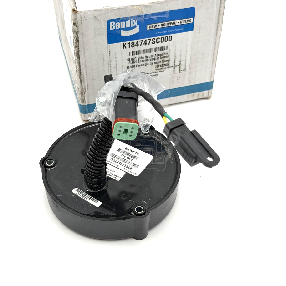 Top-down view of the Bendix BlindSpotter SLR20 side radar sensor, highlighting the white product labels with part numbers K180500 and B500B13506. Code: 85112391.